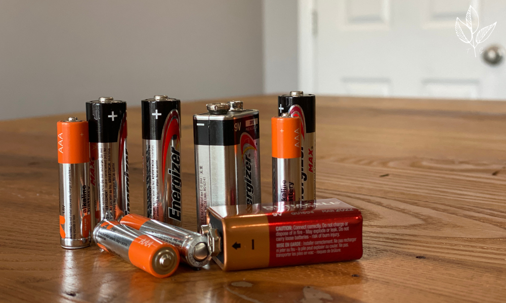 alkaline batteries are displayed on top of a wooden table