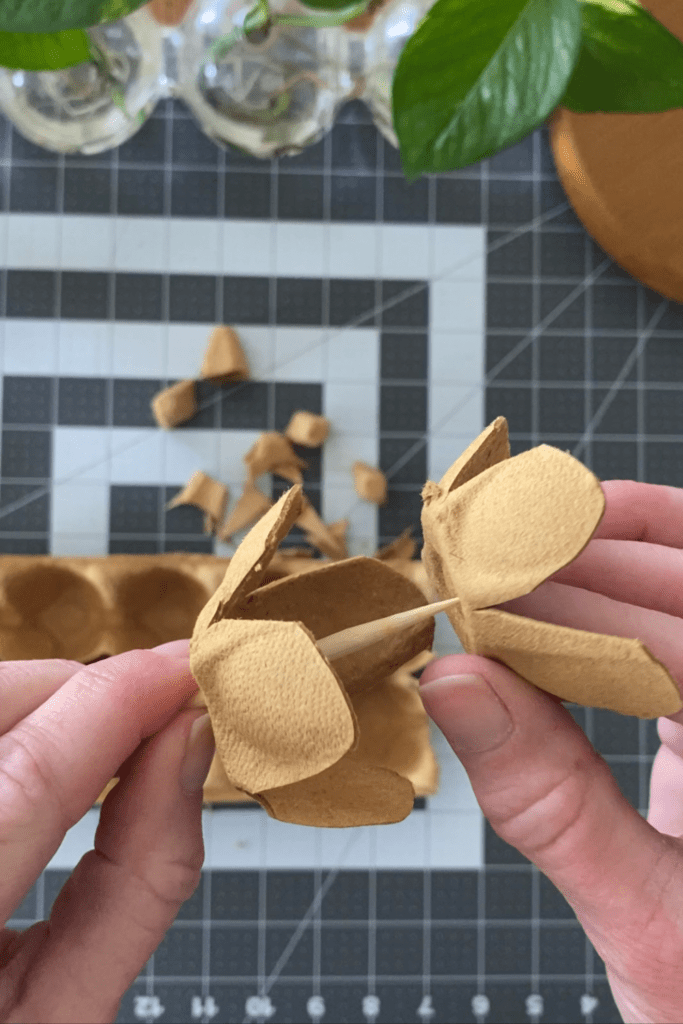 Use a bamboo skewer to poke a hole into the bottom of a flower-shaped egg cup.